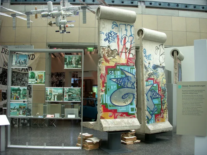 Berlin Wall segments displayed inside a museum hall.