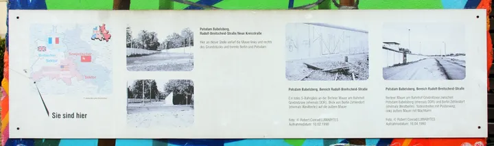 A memorial plaque beside a preserved stretch of the Berlin Wall.